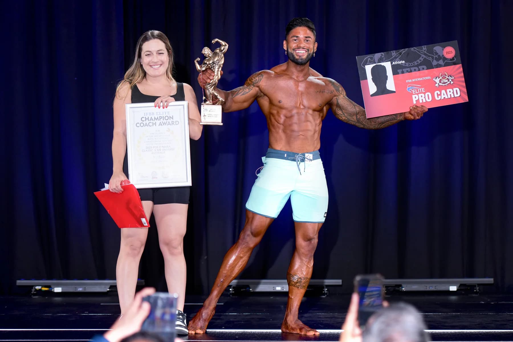 Ronan Costa receiving an award certificate and trophy